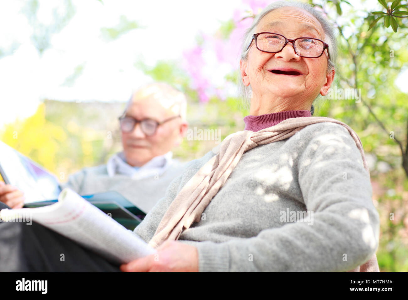 happy senior Chinese couple together in the garden outdoor daily lifestyles Stock Photo