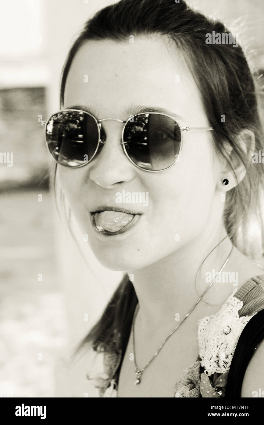 girl teenager shows tongue. black and white. a photo Stock Photo