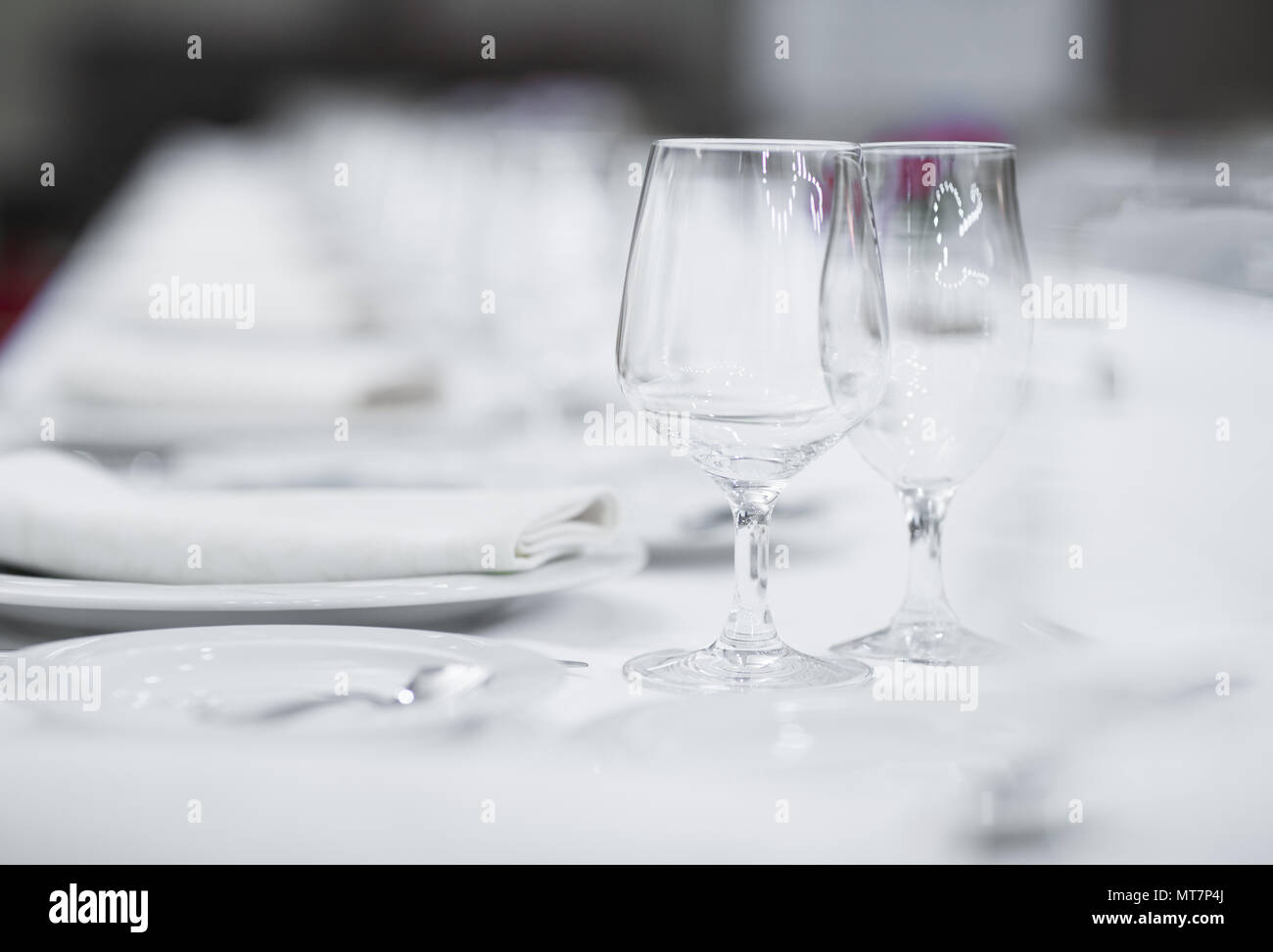 White empty plates and glasses served on a table for a celebration Stock Photo