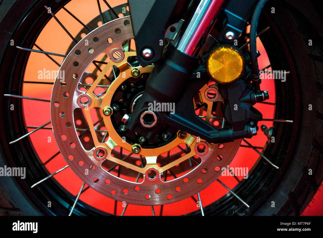Motorcycle disk brakes and suspension on modern motorbike on orange background Stock Photo