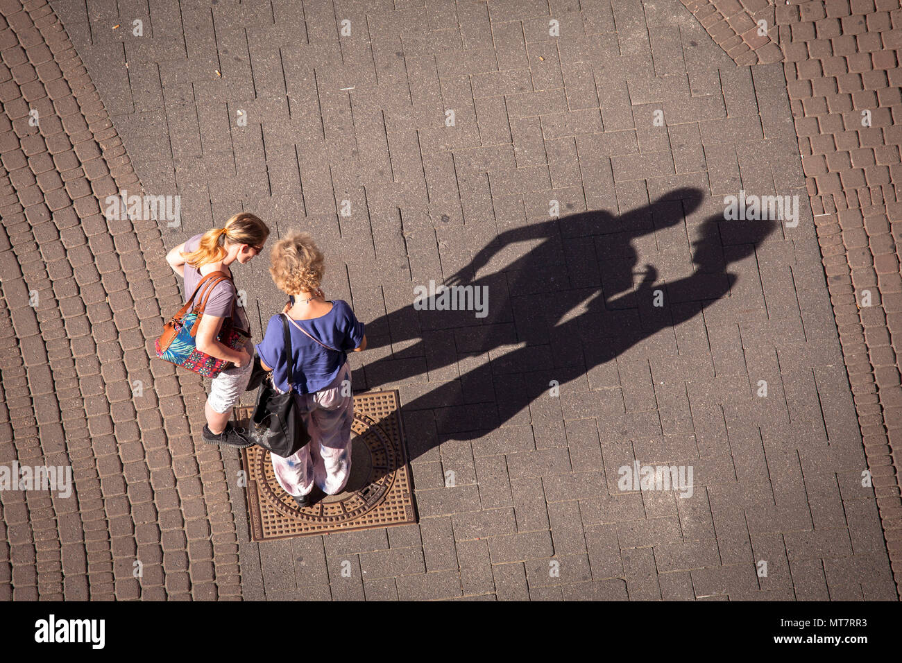 Germany, Cologne, people on the shopping street Schildergasse throw long shadows.  Deutschland, Koeln, Menschen auf der Einkaufsstrasse Schildergasse  Stock Photo