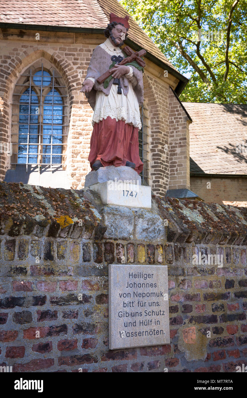 Germany, Cologne, statue John of Nepomuk on the wall of the church Alt Sankt Katharina in the district Niehl.  Deutschland, Koeln, Statue des Heiligen Stock Photo