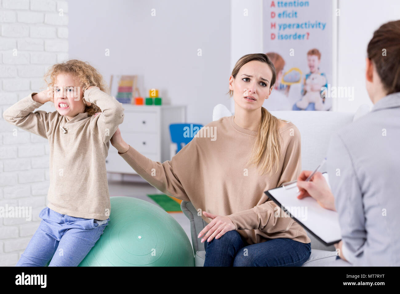 Problem child and desperate mother at psychological centre Stock Photo