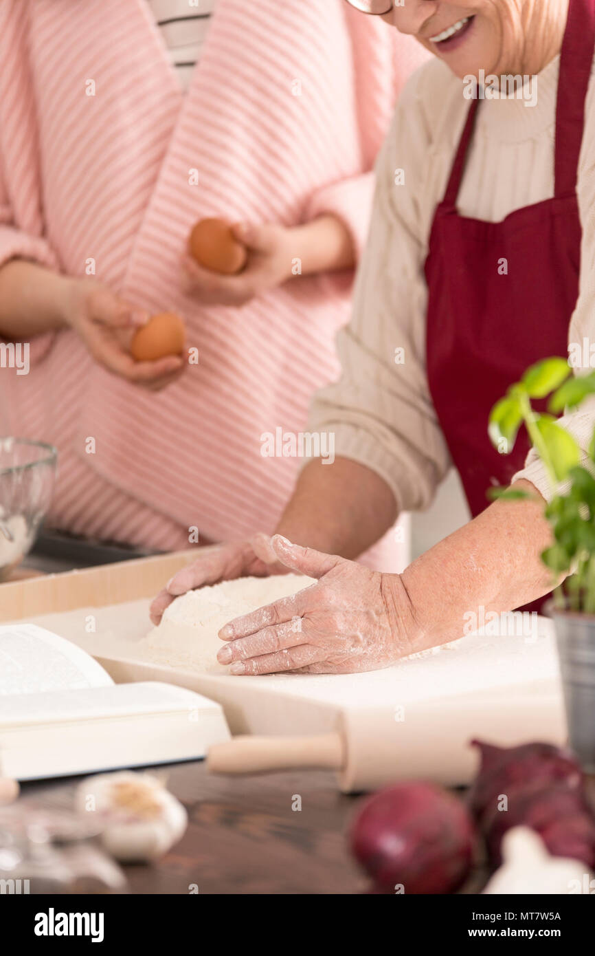 Happy women baking a cake in a kitchen Stock Photo
