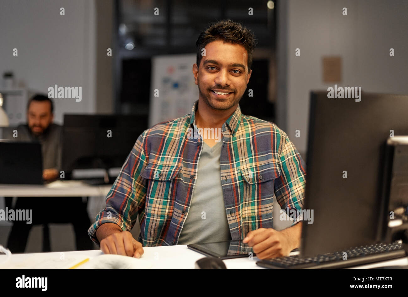 creative man with tablet pc at night office Stock Photo