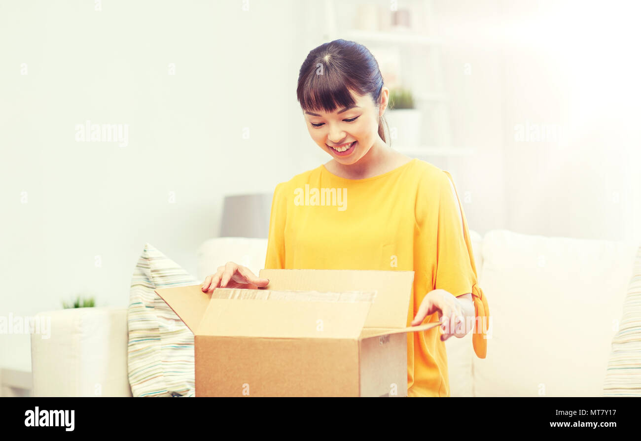 happy asian young woman with parcel box at home Stock Photo - Alamy