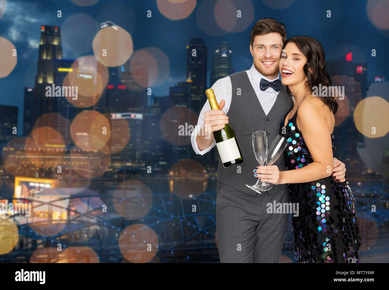 happy couple with champagne and glasses at party Stock Photo
