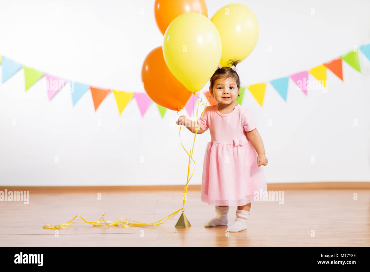 happy baby girl with balloons on birthday party Stock Photo - Alamy
