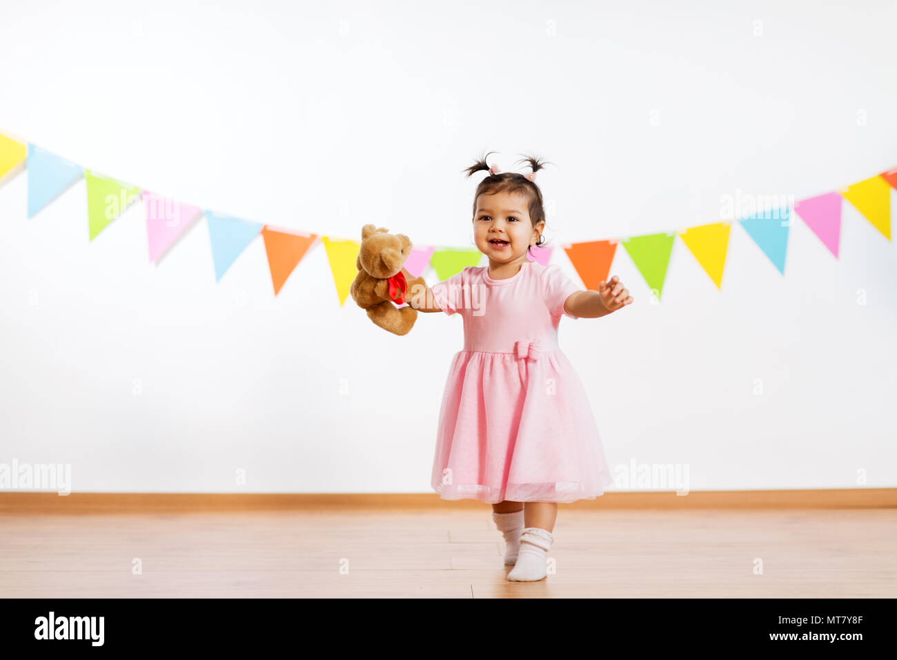 happy baby girl with teddy bear on birthday party Stock Photo - Alamy