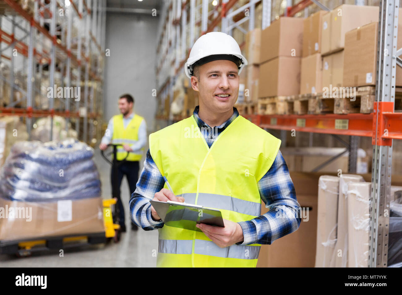 warehouse worker with clipboard in safety vest Stock Photo