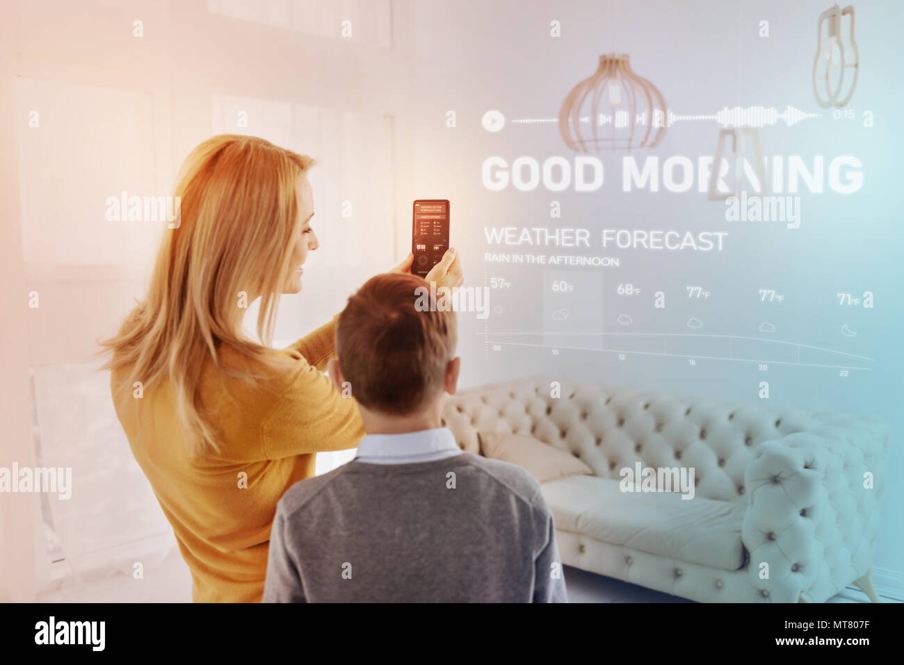 Cheerful woman smiling while checking weather forecast Stock Photo