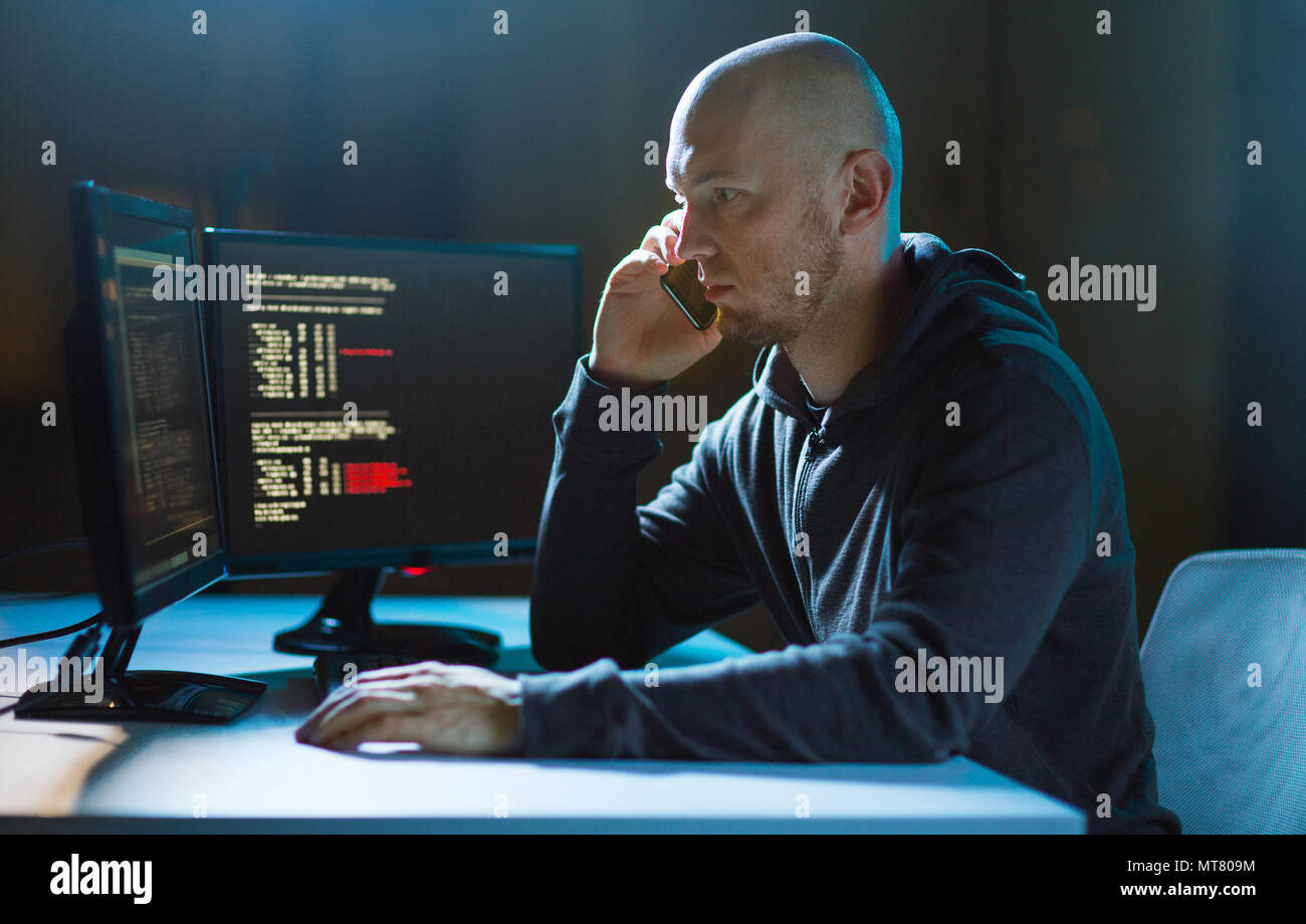 hacker with program on computer calling on cell Stock Photo - Alamy