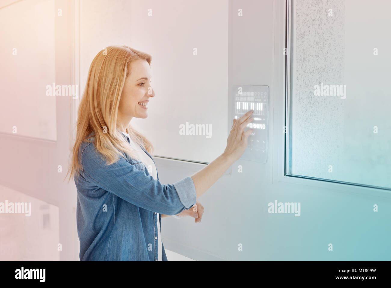 Positive programmer entering password while using her modern device Stock Photo