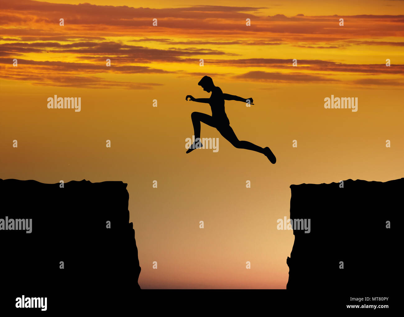 Concept image for courage and success with fitness and sport with a person making a big jump between rocks Stock Photo