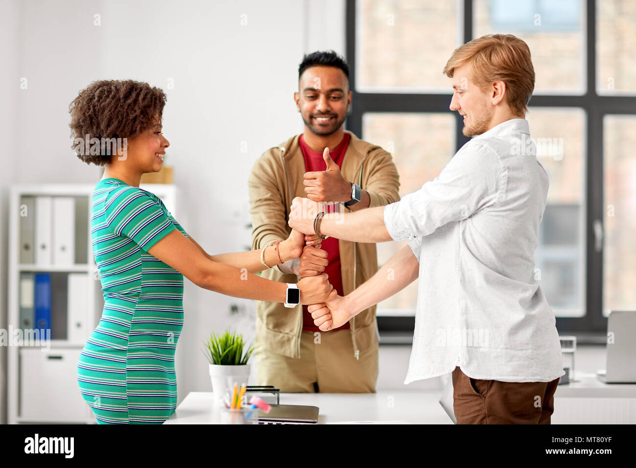 happy creative team making high five at office Stock Photo