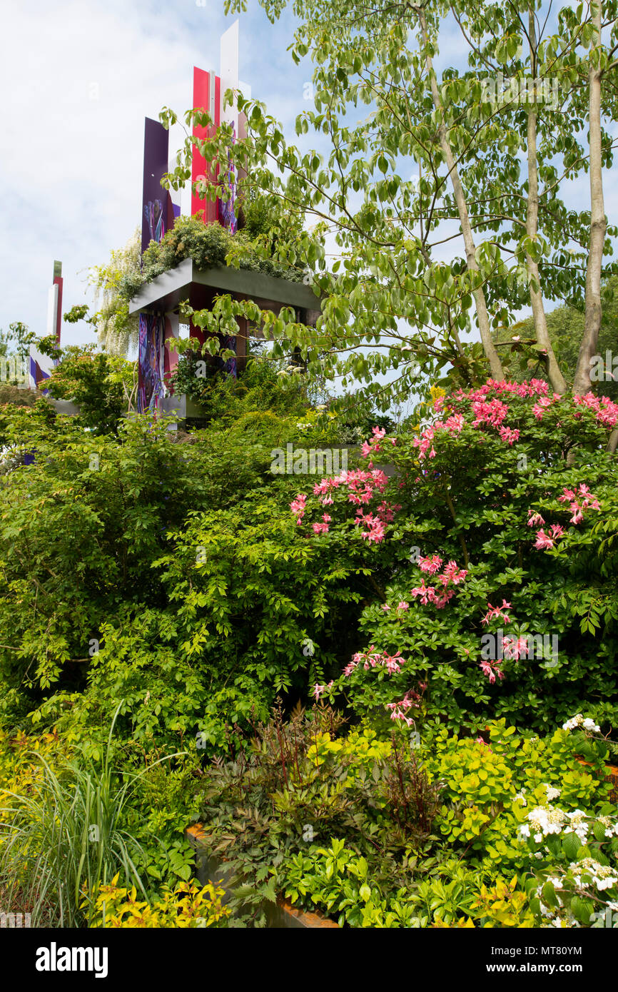 Woodland planting surrounding a tower in he Wuhan Water Garden designed by Laurie Chetwood and Patrick Collins at The RHS Chelsea Flower Show 2018, Lo Stock Photo