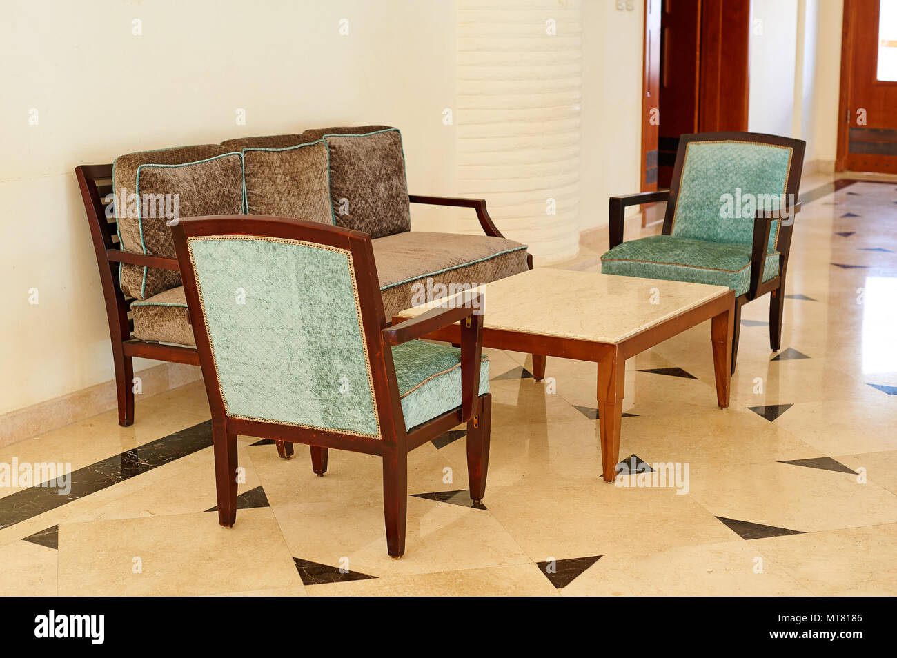 Comfortable sofa sea with two armchairs and a table with interior