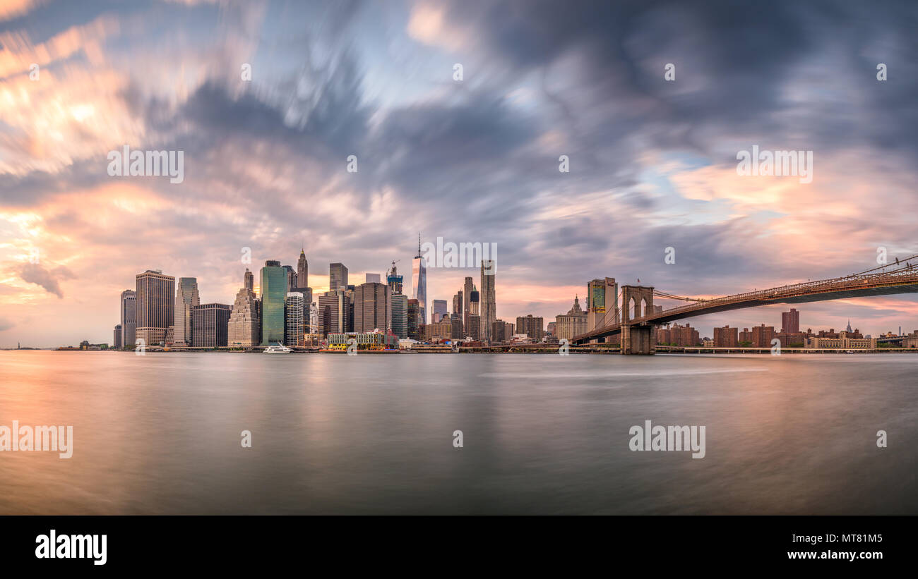 New York, New York, USA skyline of Manhattan on the East River with Brooklyn Bridge a dusk. Stock Photo