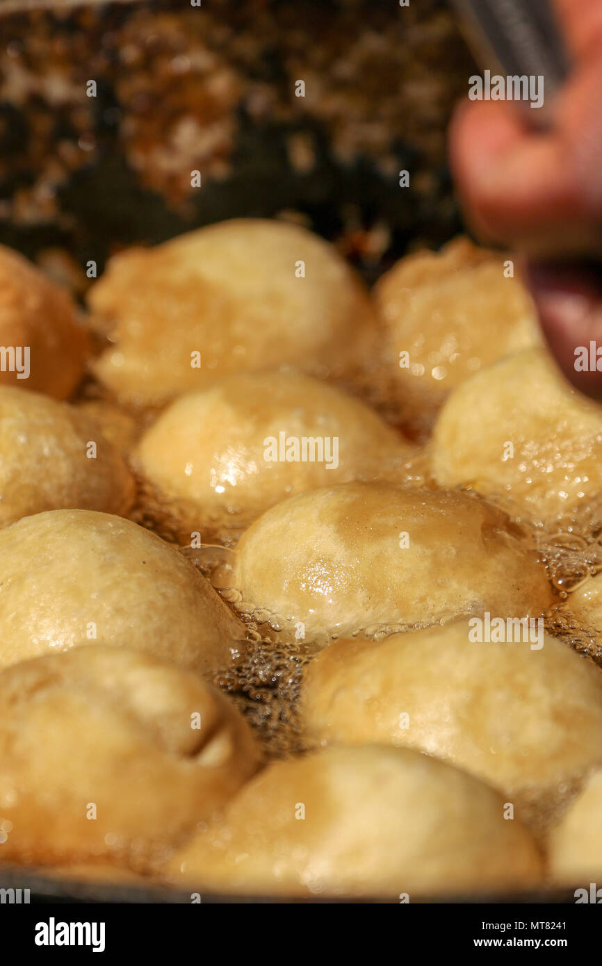 Caribbean flour dumplings frying in hot oil Stock Photo Alamy