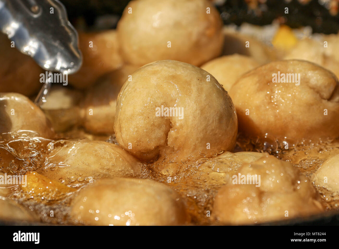 Caribbean flour dumplings frying in hot oil Stock Photo Alamy