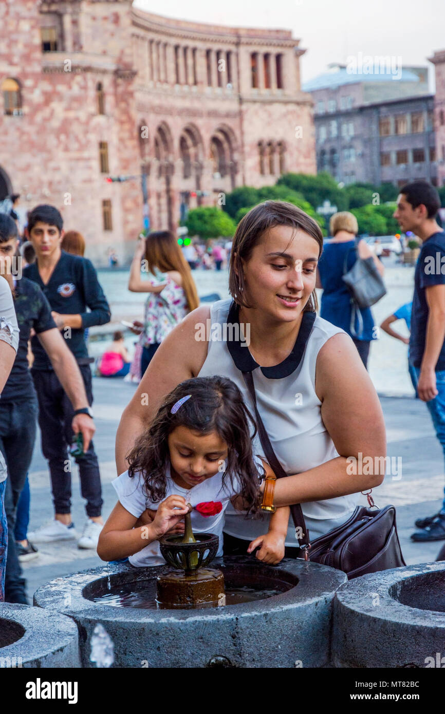 YEREVAN, ARMENIA AUGUST 2 People drinking water from the fountain at