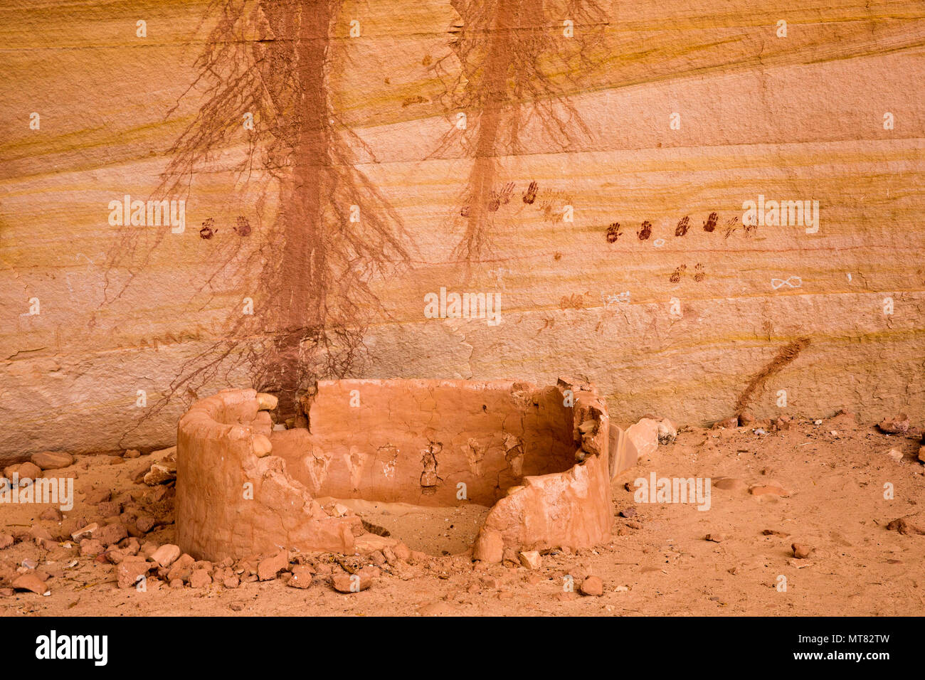 Ancient Ancestral Puebloan historic site structure with pairs of handprint pictographs on the back wall of a cliff dwelling in southeastern Utah, Unit Stock Photo