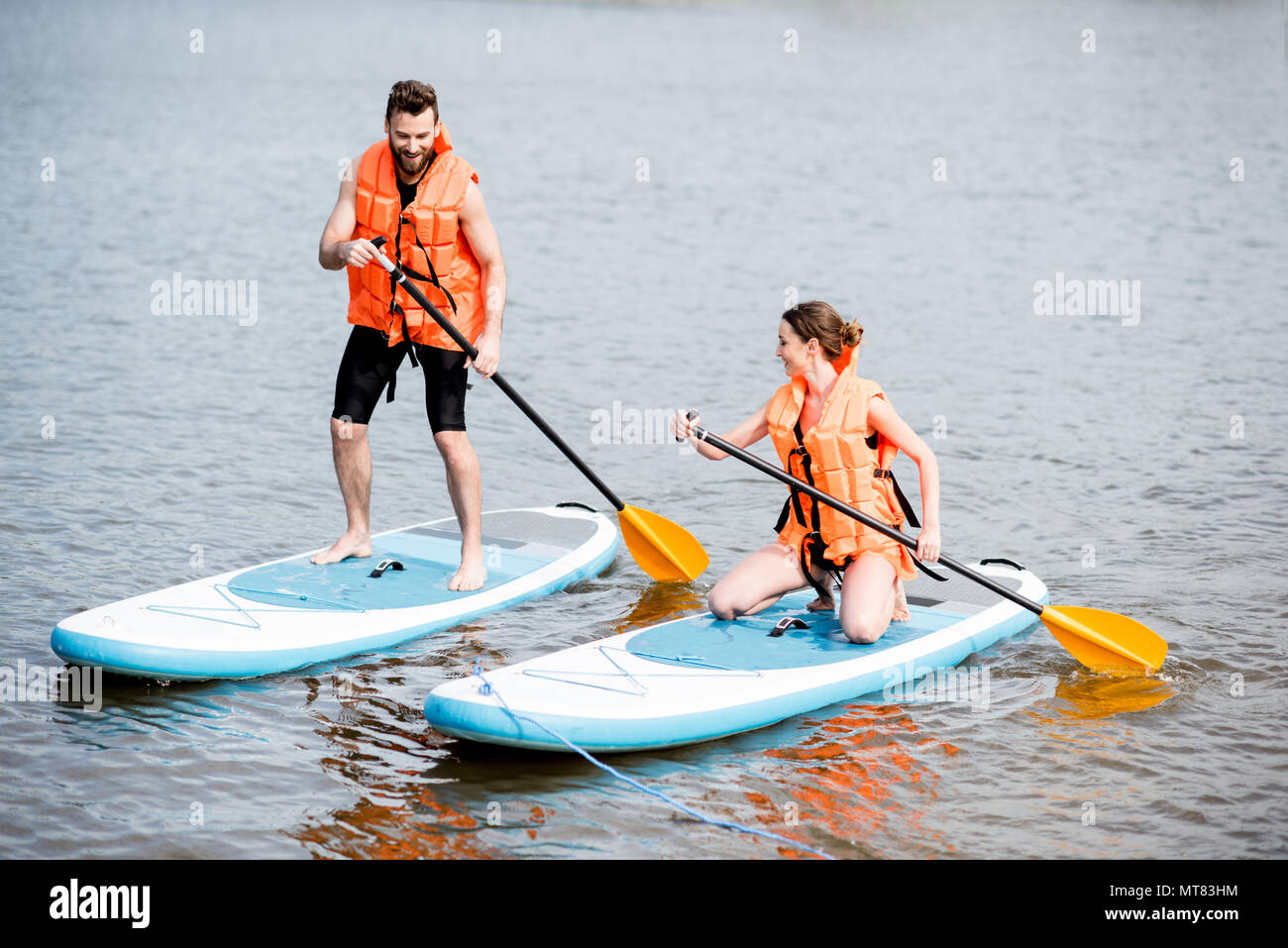 Couple rowing on the stand up paddleboard Stock Photo