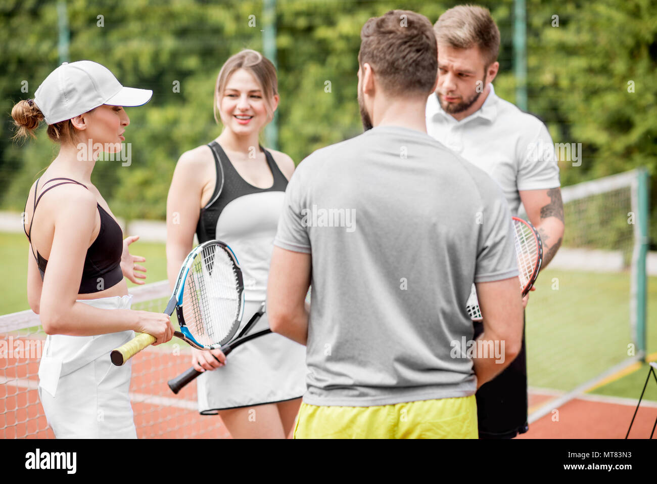 Friends on the tennis court Stock Photo - Alamy