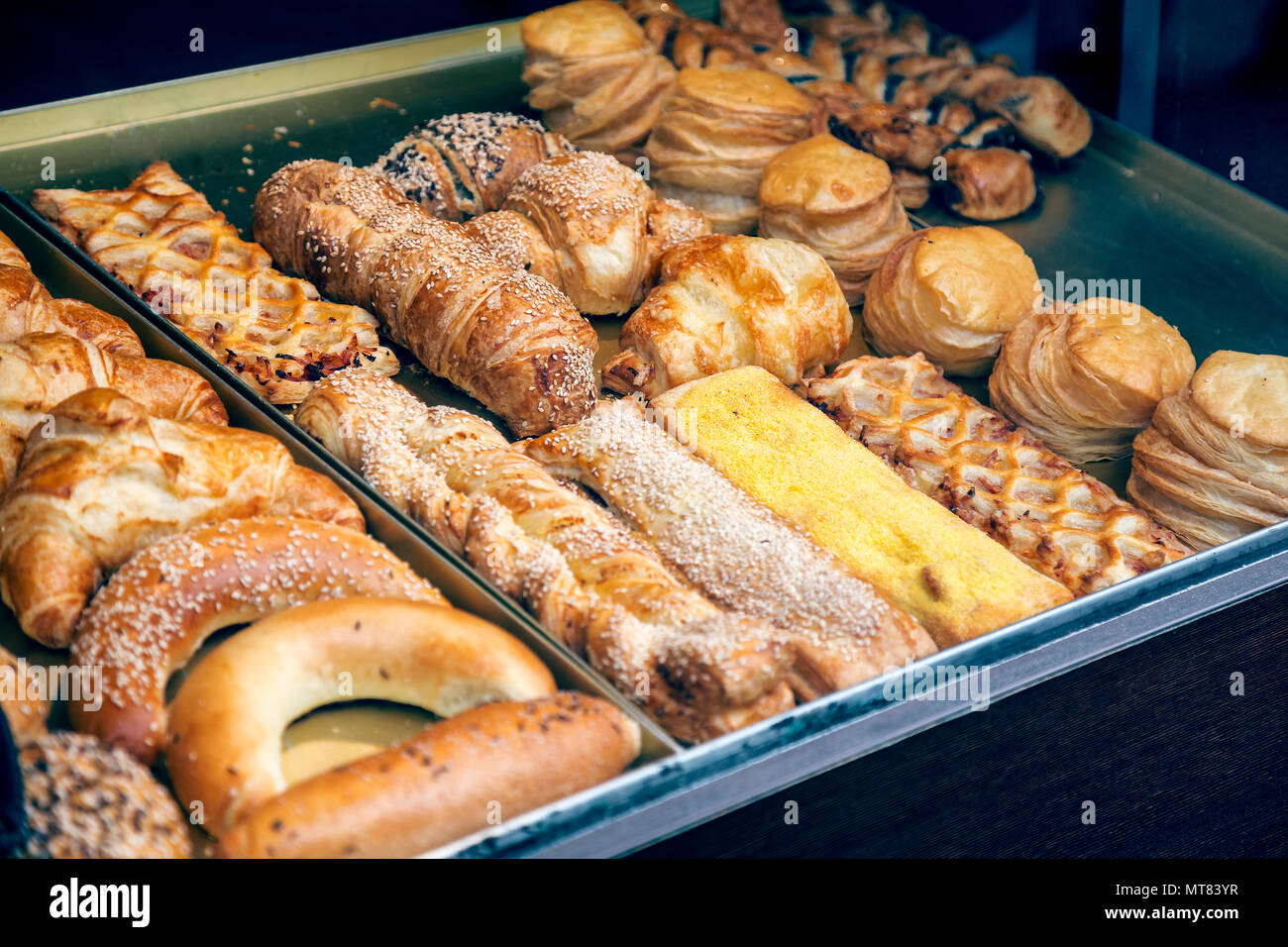Pastries and variety of baked goods in a bakery window display