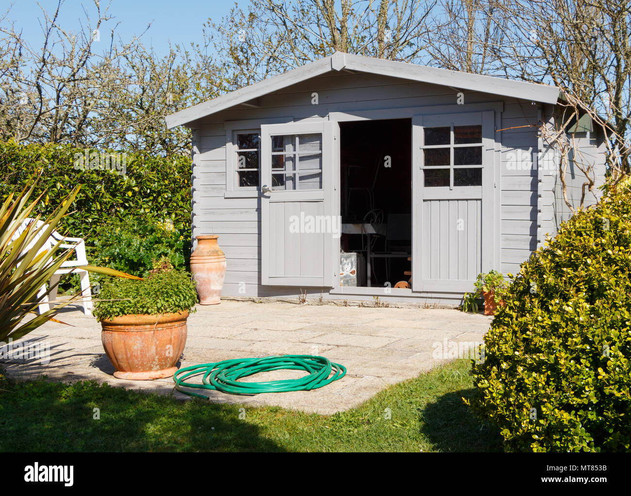 Shed with terrace in a garden during spring Stock Photo