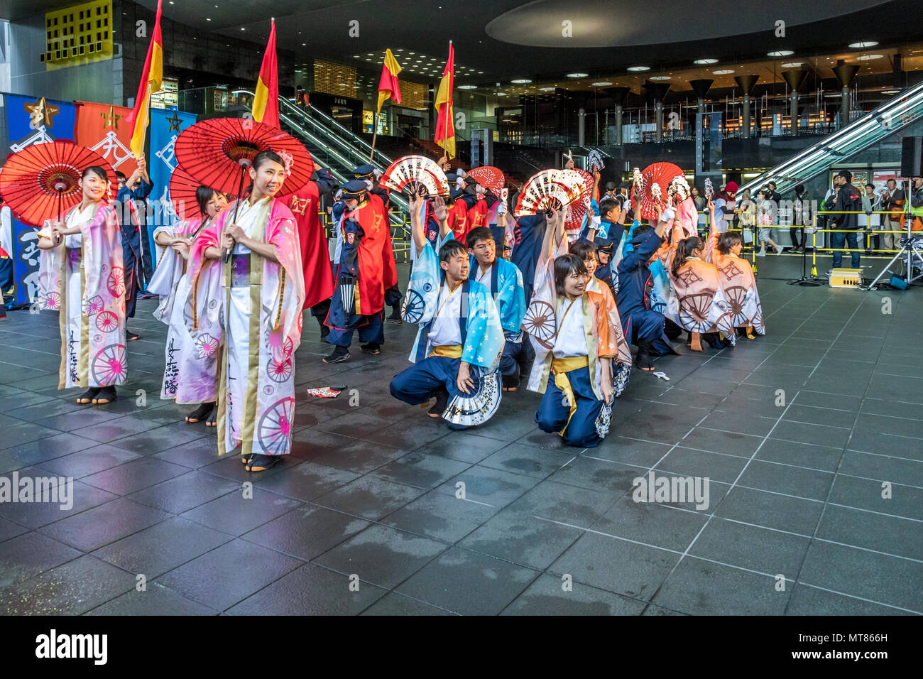 Japanese dancers performing yosakoi dance around Kyoto railway station