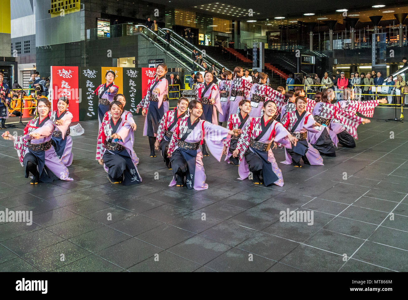 Japanese dancers performing yosakoi dance around Kyoto railway station
