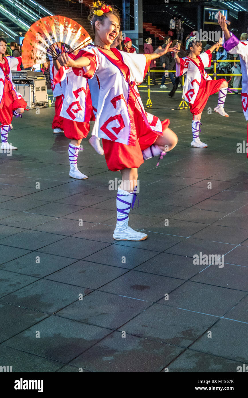 Japanese dancers performing yosakoi dance around Kyoto railway station