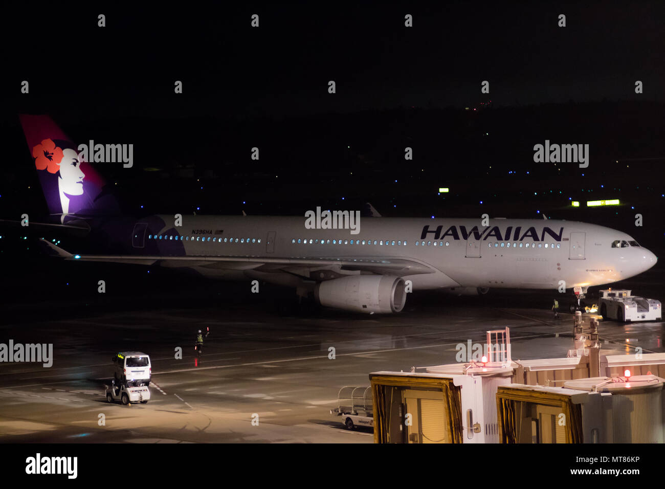 Tokyo, Japan - 08/01/2017: A Hawaiian Airline Airbus A330-200 taxiing in preparation for Take-off at night in Narita Airport. Stock Photo