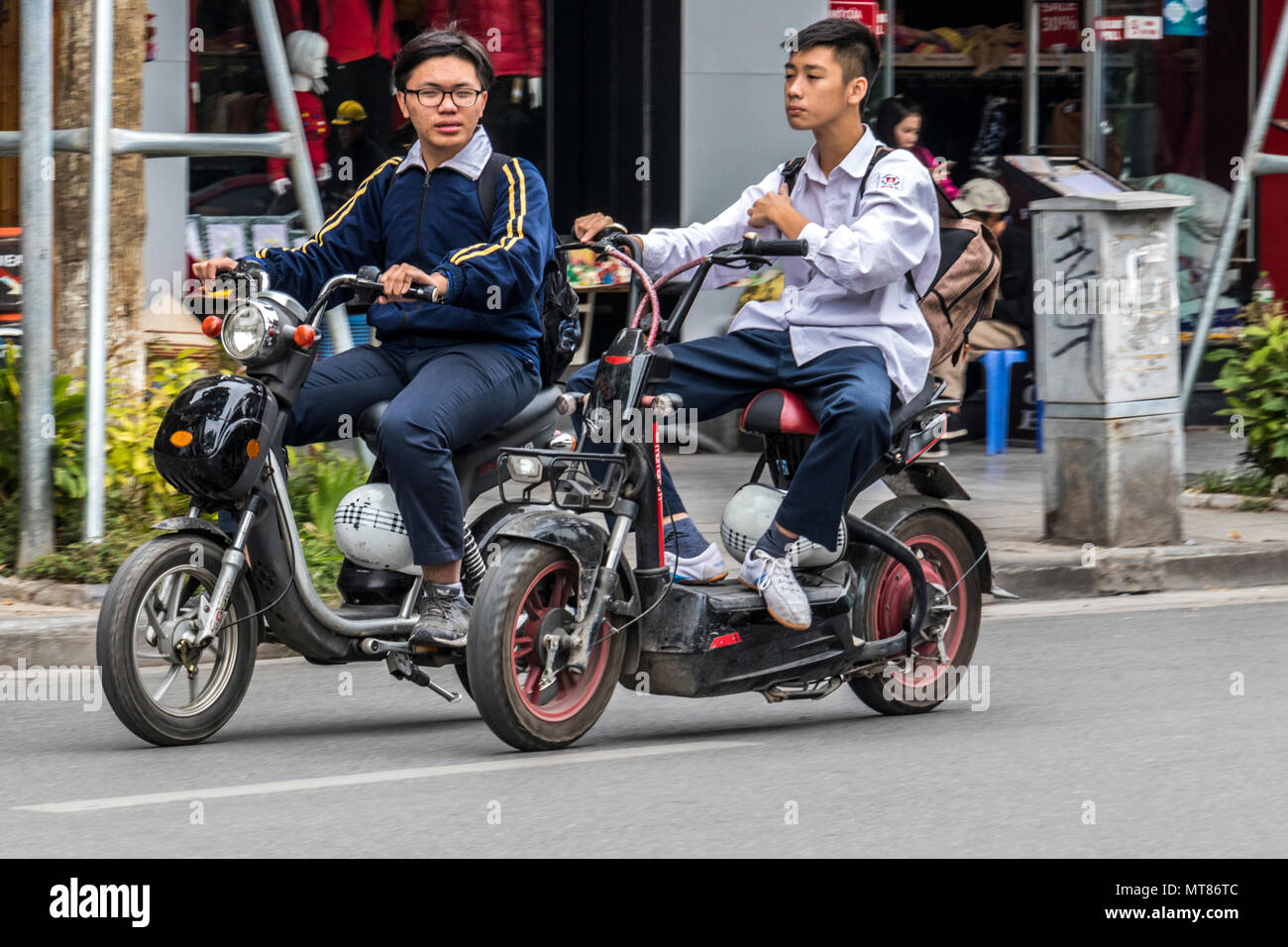 Vietnamese teenagers riding battery powered scooters in Hanoi Vietnam Stock Photo Alamy