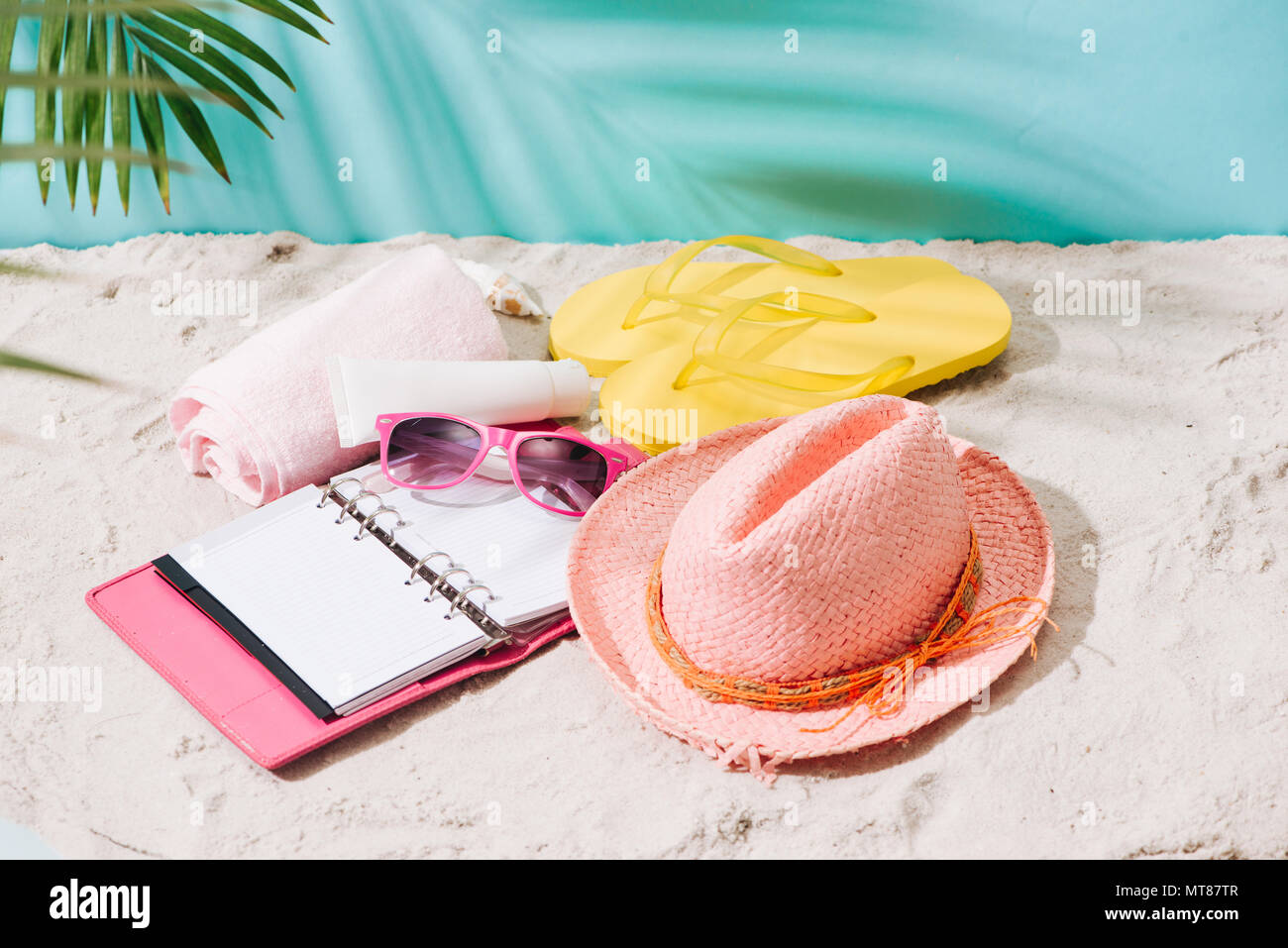 Summer accessories on sandy beach. Summer exotic relaxation concept. Copyspace for text Stock Photo