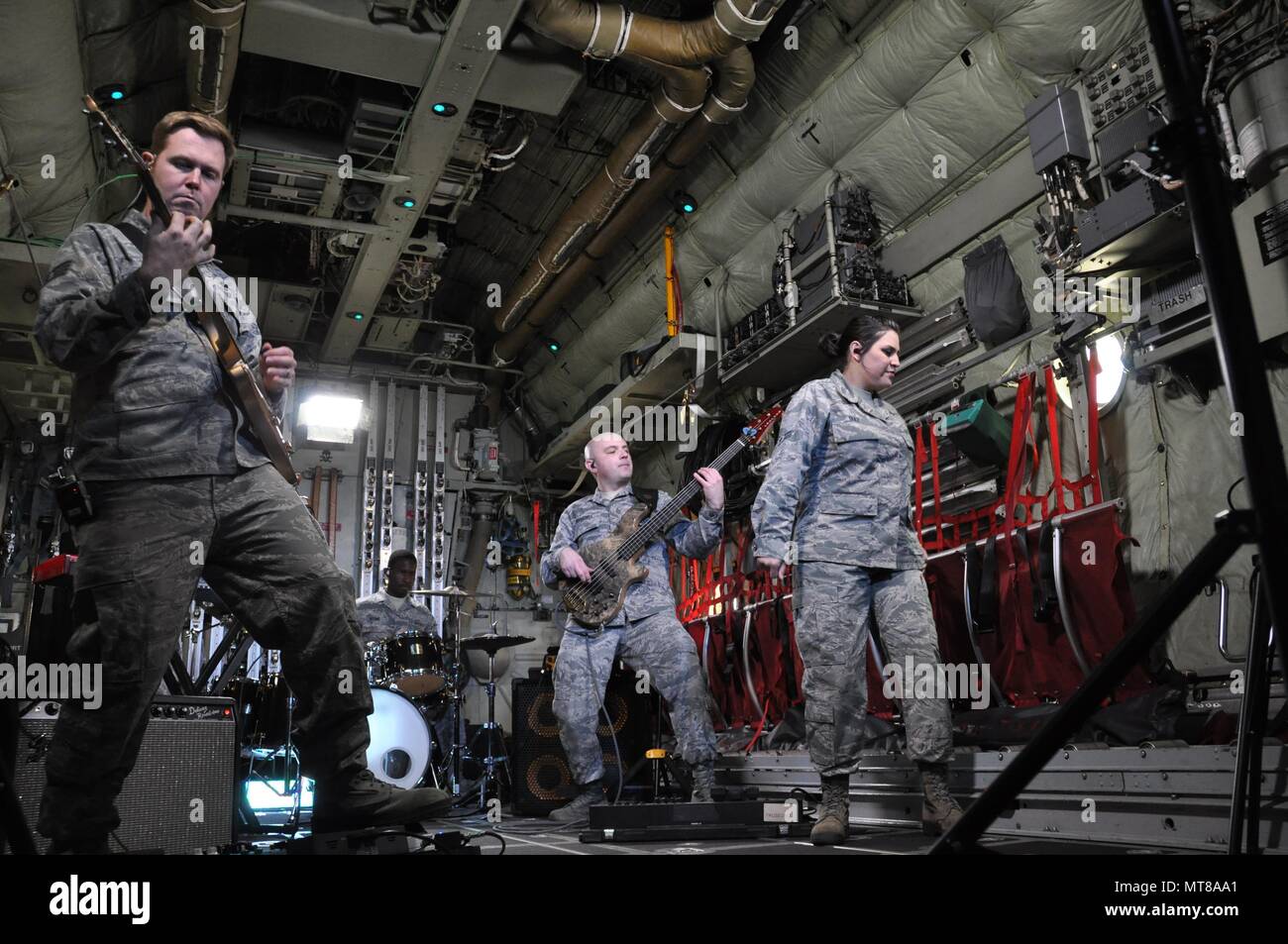 Members of the United States Air Force Academy Band’s, “Blue Steel,” perform inside an Air Force Reserve Command C-130 Hercules aircraft assigned to the 302nd Airlift Wing while recording scenes for their newest music video featuring the song “Fly Higher,” May 1, at Peterson Air Force Base, Colo. Pictured left to right are, Staff Sgts. Joe Gacioch, guitarist, Quincy Brown, drummer, Colin Trusedell, bassist, and Airman 1st Class Danielle Diaz, vocalist. The music video can be found here: https://www.youtube.com/watch?v=aSq37dNrzM4. (Air Force photo/Staff Sgt. Frank Casciotta) Stock Photo