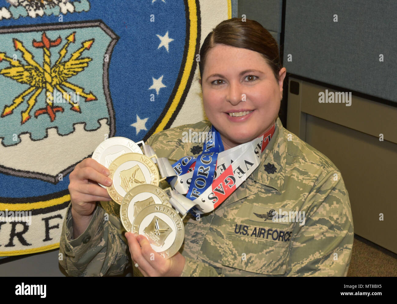 Lt. Col. Jackie Burns, 552nd Air Control Group, 552nd Air Control Wing, displays the medals she earned at the Wounded Warrior Trials at Nellis Air Force Base, Nev., Feb. 17. Burns earned Silver Medals in 5K cycling, 100-meter free style, discus and a Bronze Medal in the 50-meter backstroke. Burns was selected as a primary Wounded Warrior team member and will compete in the Warrior Games June 30-July 8 in Chicago.  (Air Force photo by Ron Mullan) Stock Photo