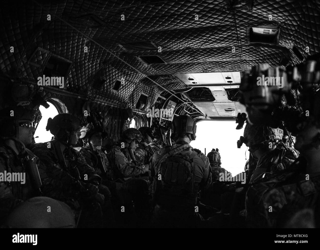 Green Berets from 10th Special Forces Group (Airborne) sit inside a CH-47 Chinook helicopter as they conduct a training exercise March 1, 2017 at Nellis Air Force Base, Nevada. The training integrated the U.S. Air Force Weapons School and included joint, scenario-based training that enhanced tactical experts and leaders with real-world experience in advanced weapons and tactics. (U.S. Army photo by Staff Sgt. Amber Martin) Stock Photo