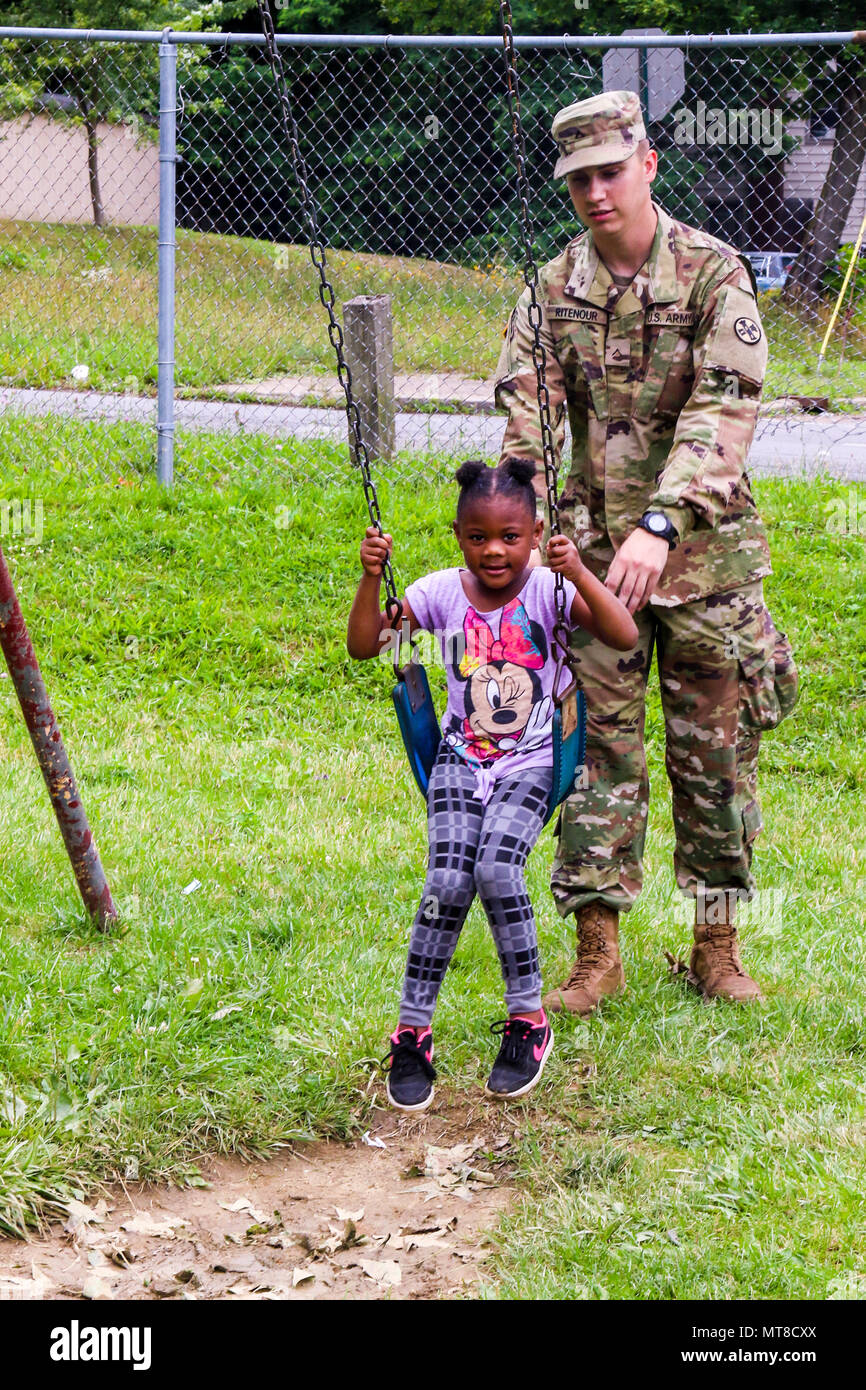 Soldiers of the Ohio National Guard’s 16th Engineer Brigade spent part of their annual training period this summer providing demolition support for the city of Youngstown as part of the South Side Blight Removal and Greening (SS-BRAG) project, through the Department of Defense Civil-Military Innovative Readiness Training Program. During breaks, when not tearing down decrepit houses, Soldiers spent time building relationships with local residents. (Ohio National Guard photo by Staff Sgt. Michael Carden) Stock Photo