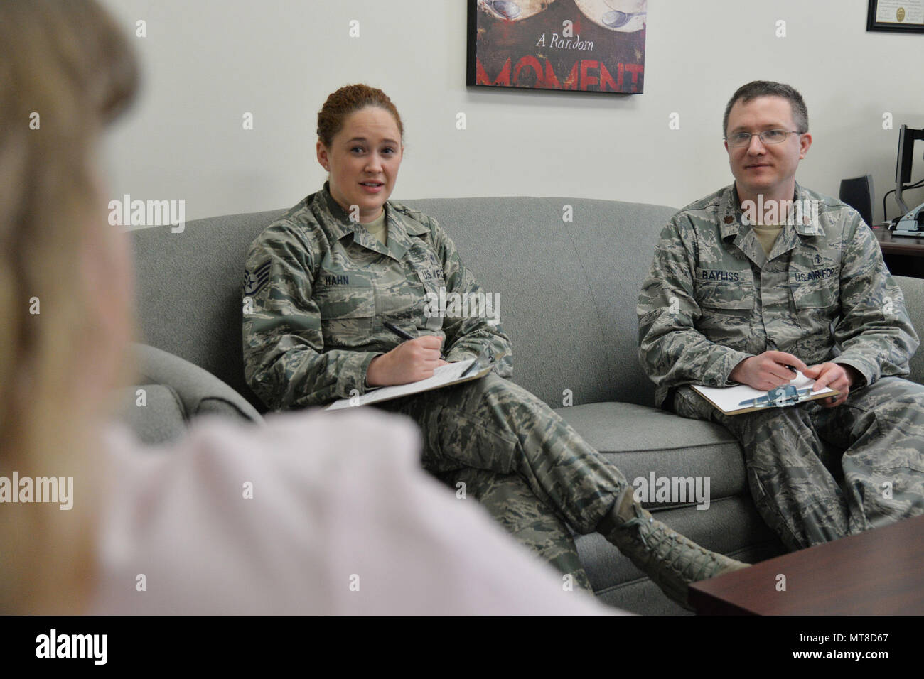 Staff Sgt. Allison Hahn, 341st Medical Operations Squadron NCO in charge of mental health, and Maj. Corey Bayliss, 341st MDOS Alcohol and Drug Abuse Prevention and Treatment program manager, speak to a patient March 21, 2017, at Malmstrom Air Force Base, Mont. Mental health technicians assist 50-75 patients a week. (U.S. Air Force photo/Airman 1st Class Daniel Brosam) Stock Photo