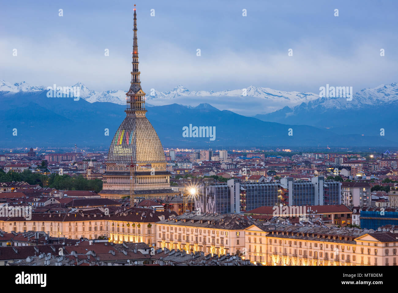 Torino, Italy - May 14, 2018: Turin skyline at dusk, panorama cityscape with the Mole Antonelliana showing 'International Book Fair 2018' sign. Scenic Stock Photo