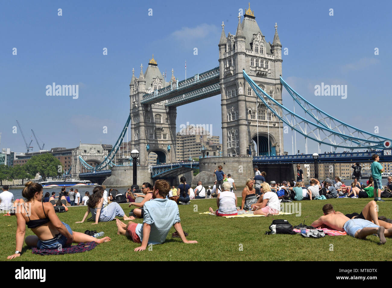 People enjoy the hot weather at Potters Field Park, London, as Britons