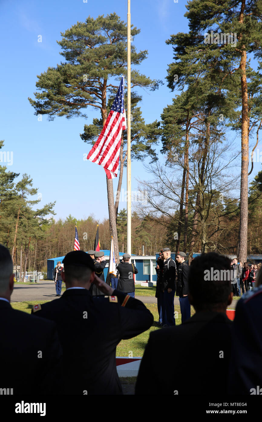 U.S. Army Lt. Col. Chris Keeshan, 2nd Signal Brigade deputy brigade commander, salutes as the American flag is raised during a ceremony marking 27 years since the last patrol along the former border between East Germany and West Germany at the Point Alpha camp, April 28, 2017 near Rasdorf, Germany. (U.S. Army photo by Staff Sgt. Brian M. Cline) Stock Photo