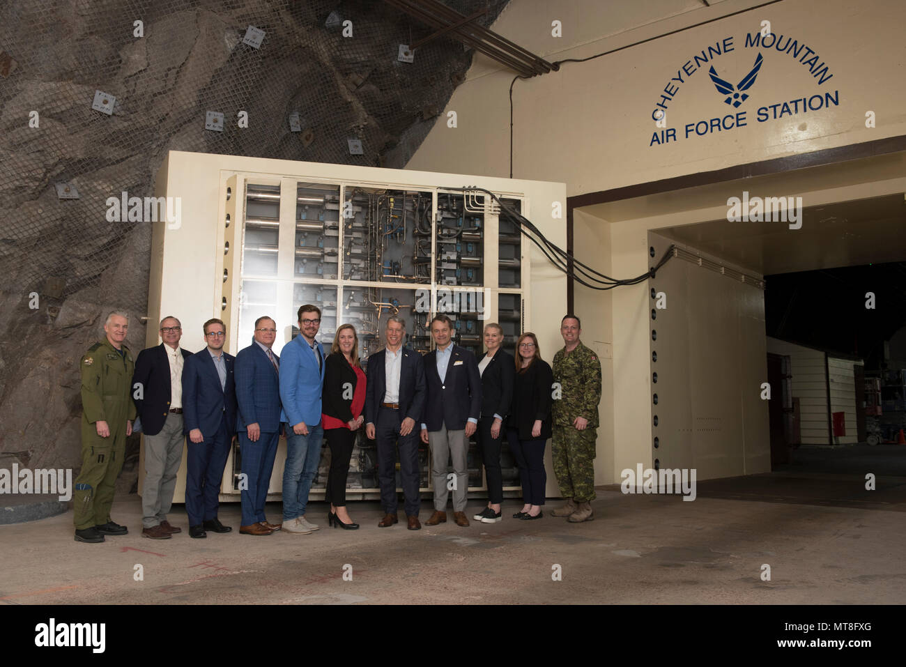 CHEYENNE MOUNTAIN AIR FORCE STATION, Colo.—The Honourable Seamus O’Regan (fourth from right), Canadian minister of veteran affairs, The Honourable Andrew Leslie (fifth from right), Canadian parliamentary secretary to the minister of foreign affairs, Jody Thomas (third from right), deputy minister of national defence, and Stephane Lessard (fourth from left), consul general of Canada, and their team arrived for a tour of Cheyenne Mountain Air Force Station, Colorado, May 11, 2018. Distinguished Canadian representatives came to Colorado to celebrate the 60th anniversary of the North American Aero Stock Photo