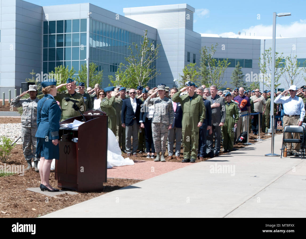 Royal Canadian Air Force Honorary Colonel Loreena McKennitt sings the Canadian and U.S. National Anthems during the unveiling ceremony for a memorial cairn outside the NORAD and USNORTHCOM headquarters building on Peterson Air Force Base, Colorado, May 11. The cairn honors the Canadian service men and women who passed away while serving at NORAD in Colorado Springs. The placement and dedication of the cairn was conducted in conjunction with the 60th Anniversary of NORAD and the U.S. Canadian binational NORAD agreement. (DoD Photo By: Jhomil Bansil) Stock Photo