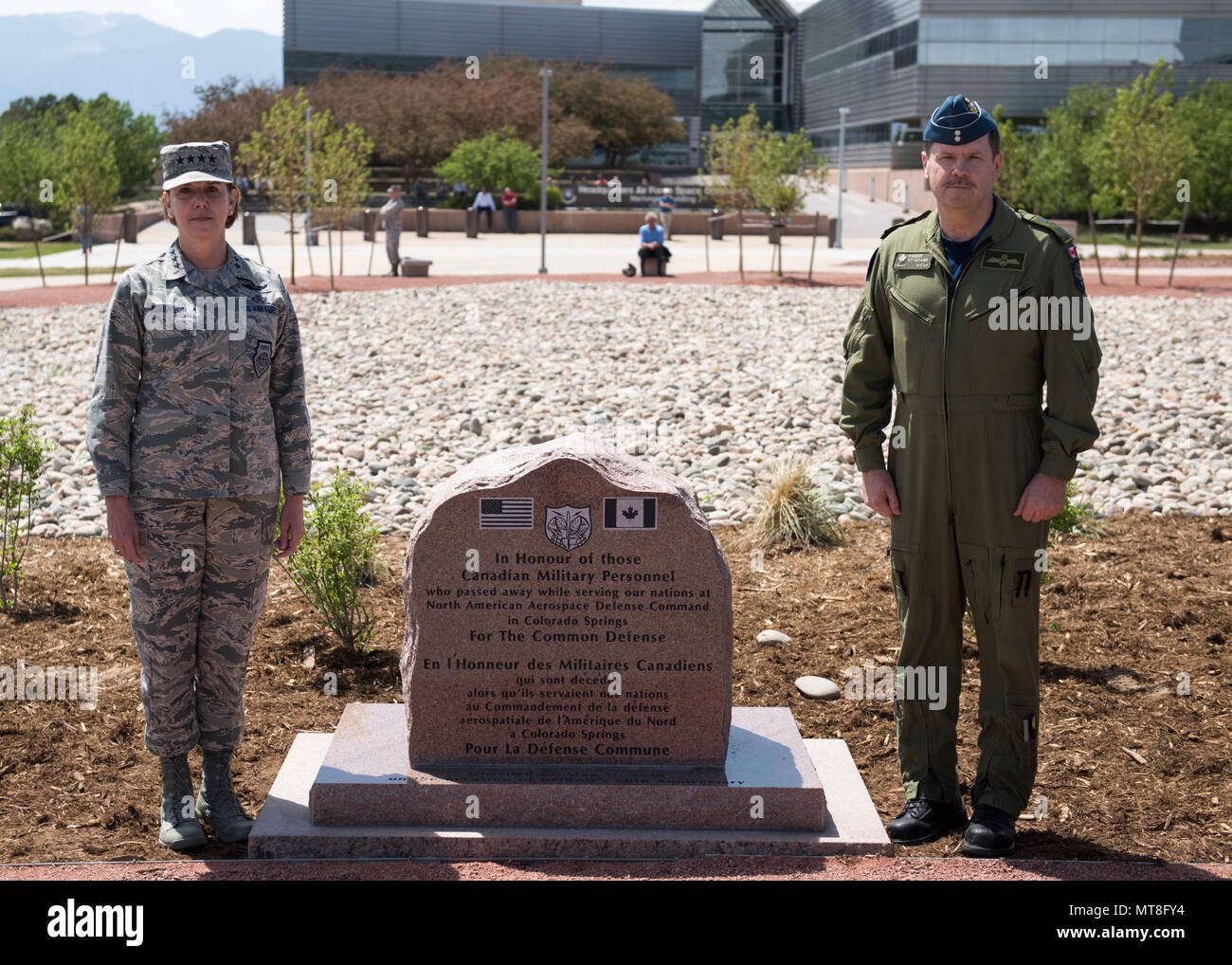 U.S. Air Force General Lori Robinson, Commander of the North American Aerospace Defense Command and U.S. Northern Command and Canadian Lt. Gen. Pierre St-Amand, the NORAD Deputy Commander pause for a photo during the unveiling ceremony for a memorial cairn outside the NORAD and USNORTHCOM headquarters building on Peterson Air Force Base, Colorado, May 11. The cairn honors the Canadian service men and women who passed away while serving at NORAD in Colorado Springs. The placement and dedication of the cairn was conducted in conjunction with the 60th Anniversary of NORAD and the U.S. Canadian bi Stock Photo