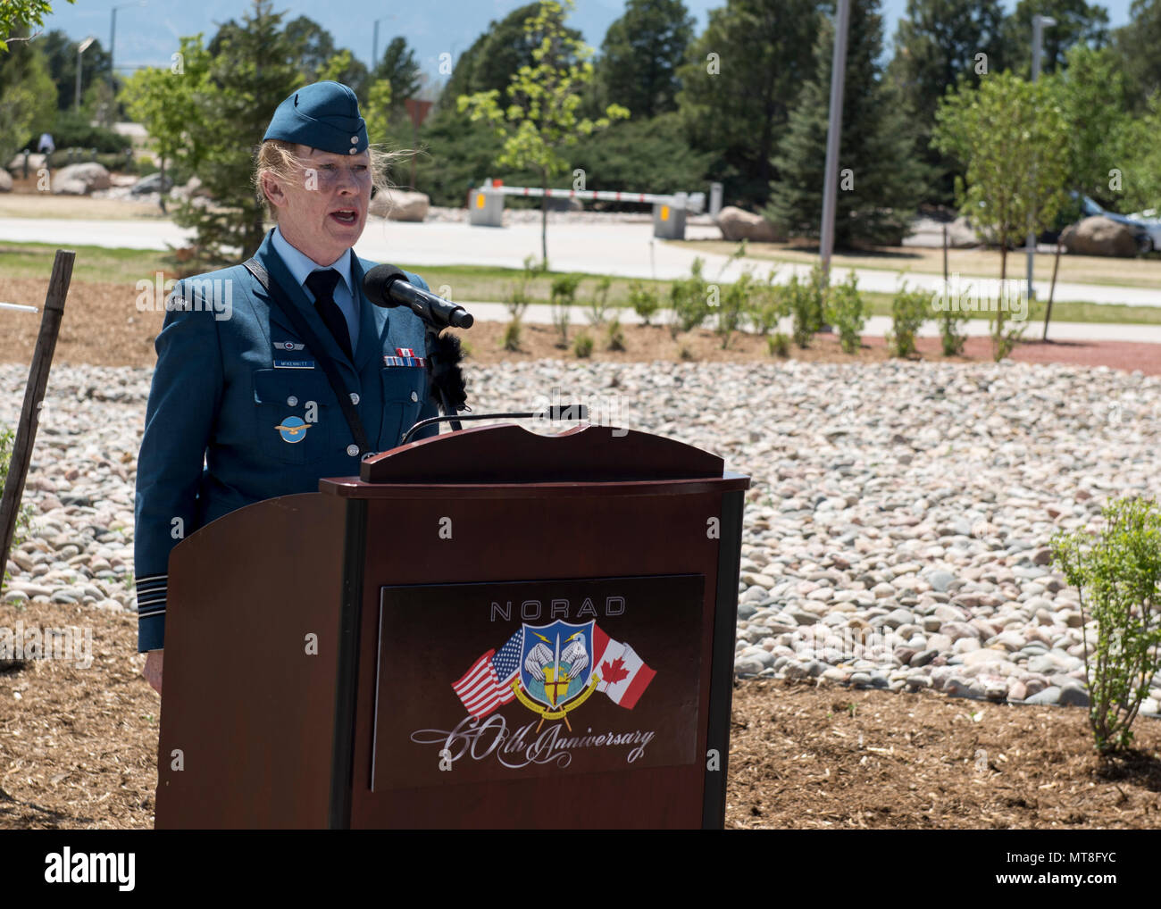 Royal Canadian Air Force Honorary Colonel Loreena McKennitt sings the Canadian and U.S. National Anthems during  the unveiling ceremony for a memorial cairn outside the NORAD and USNORTHCOM headquarters building on Peterson Air Force Base, Colorado, May 11. The cairn honors the Canadian service men and women who passed away while serving at NORAD in Colorado Springs. The placement and dedication of the cairn was conducted in conjunction with the 60th Anniversary of NORAD and the U.S. Canadian binational NORAD agreement. (DoD Photo By N&NC Public Affairs) Stock Photo
