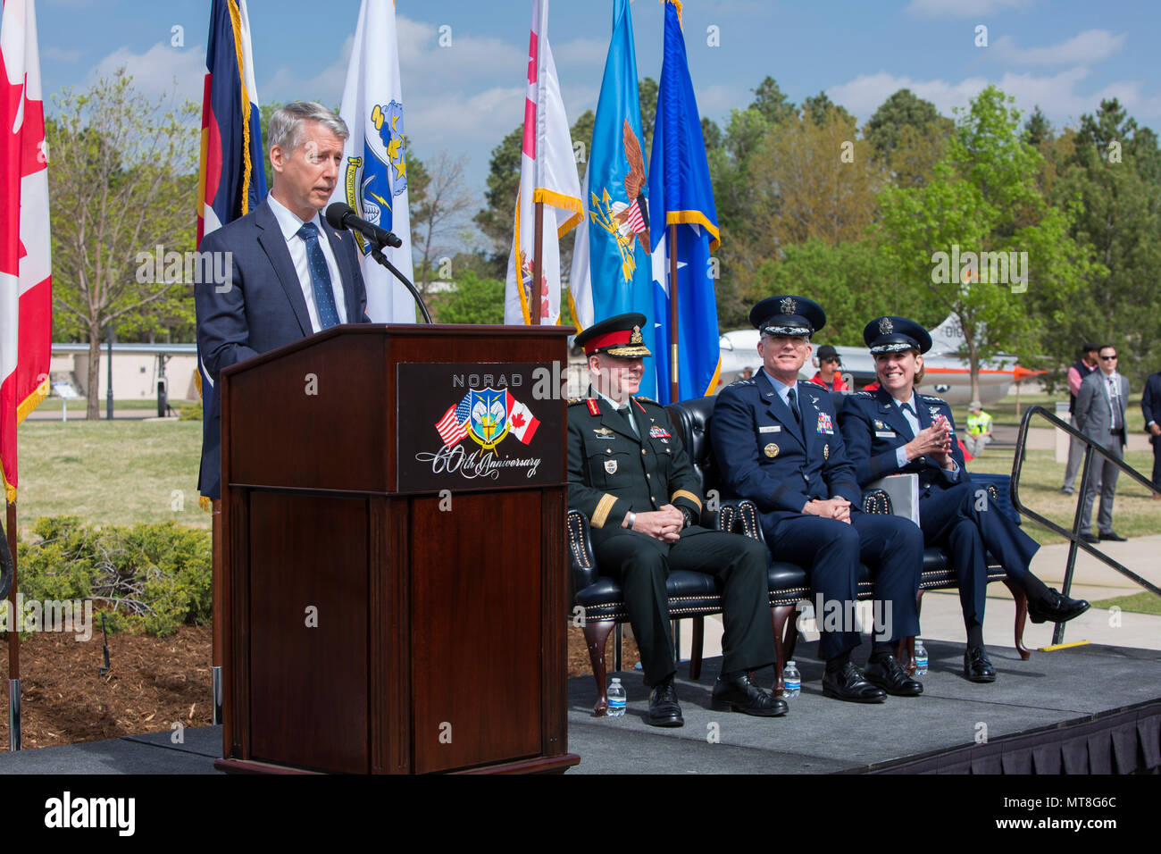 Canadian Parliamentary Secretary Andrew Leslie offers remarks from the Prime Minister, Justin Trudeau to open the North American Aerospace Defense Command’s 60th Anniversary Ceremony on Peterson Air Force Base Colorado, May 12. The ceremony and static display of various NORAD aircraft was the culmination of a three-day event, which included a media tour of Cheyenne Mountain Air Force Station, the dedication of a cairn outside the commands’ headquarters building memorializing the Canadians who have passed away while serving NORAD, and a fly over in missing-man formation performed by the Royal C Stock Photo