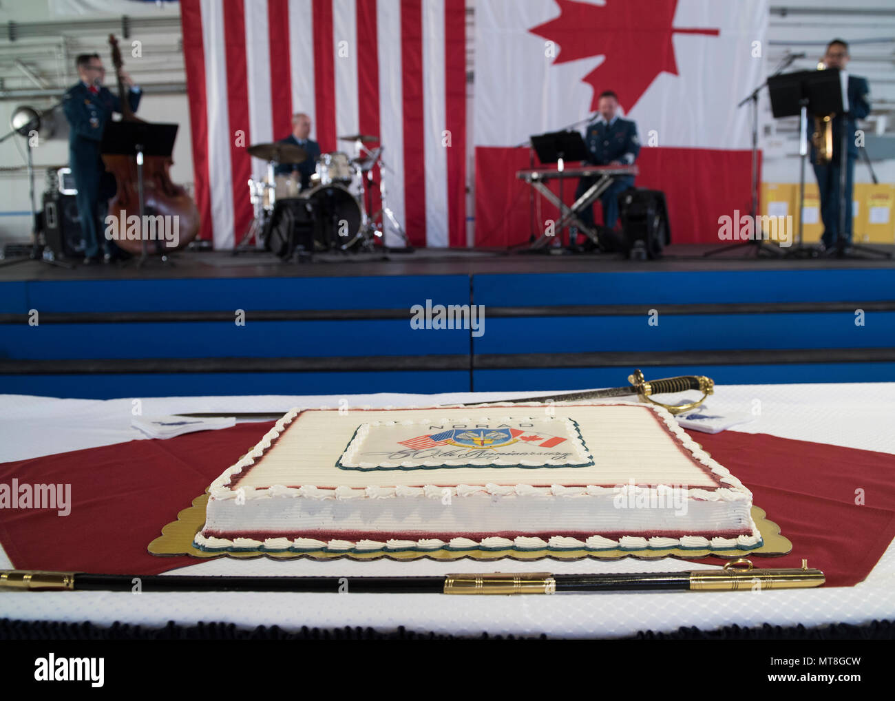 A celebratory cake is displayed during the North American Aerospace Defense Command's 60th Anniversary Ceremony on Peterson Air Force Base Colorado, May 12, 2018. The ceremony and static display of various NORAD aircraft was the culmination of a three-day event, which included a media tour of Cheyenne Mountain Air Force Station, the dedication of a cairn outside the commands' headquarters building memorializing the Canadians who have passed away while serving NORAD, and a fly over in missing-man formation performed by the Royal Canadian Air Force's Snowbirds aerial demonstration team. (DoD pho Stock Photo